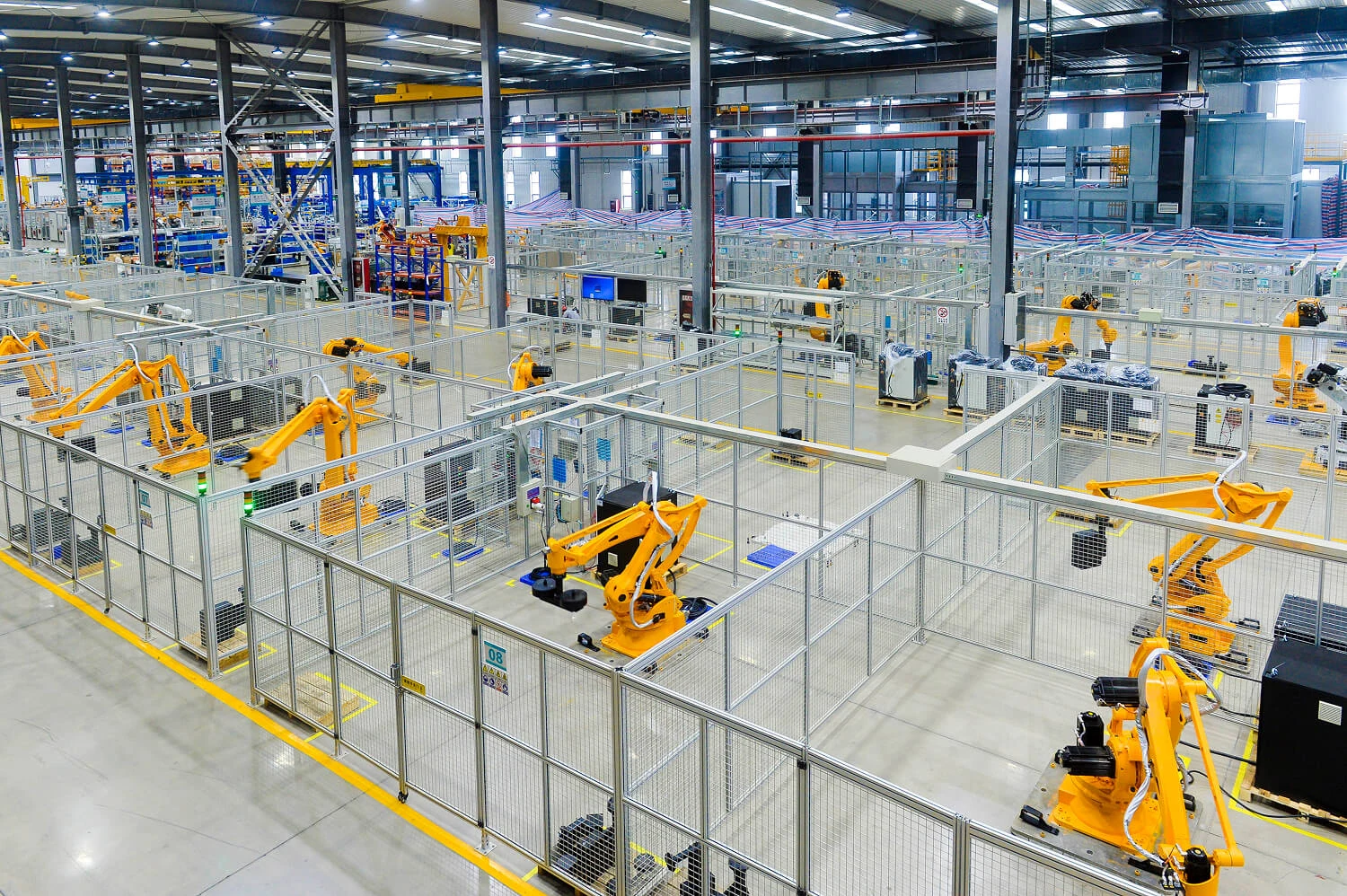 ESTUN industrial hall with multiple cells and yellow robot arms.