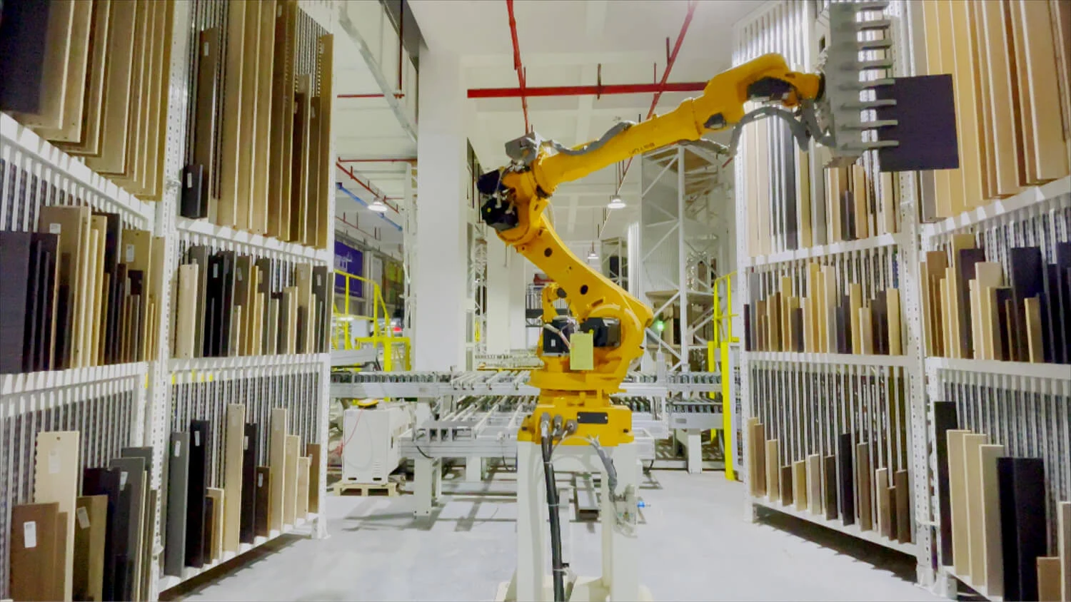 ESTUN robot handling a panel between racks in an industrial installation.