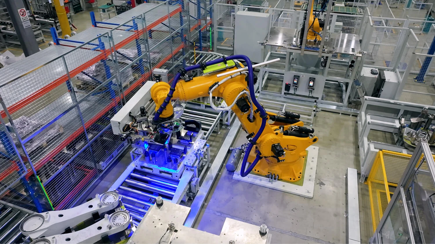 ESTUN industrial cell with robot arms, fixtures and conveyors.
